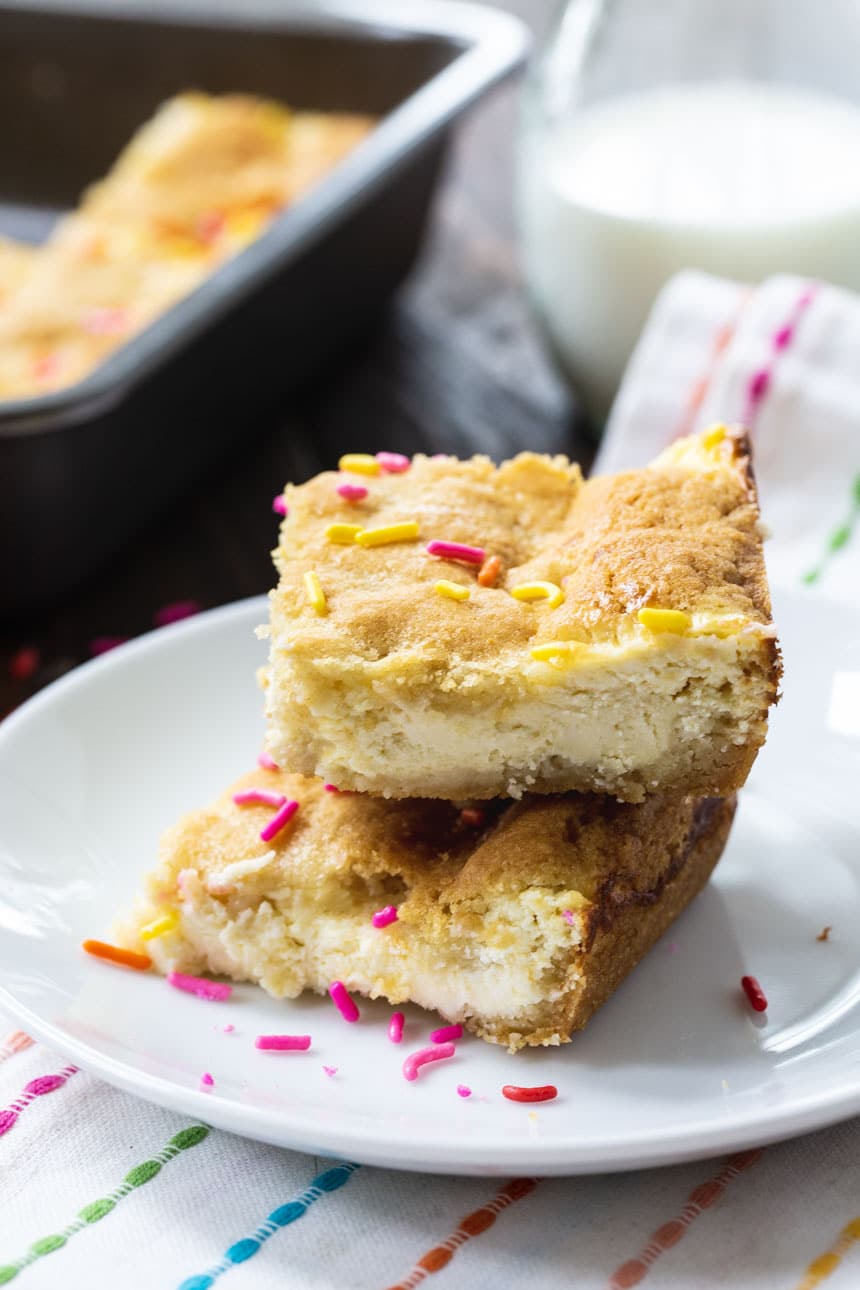 Two Sugar Cookie Cheesecake Bars on a plate.