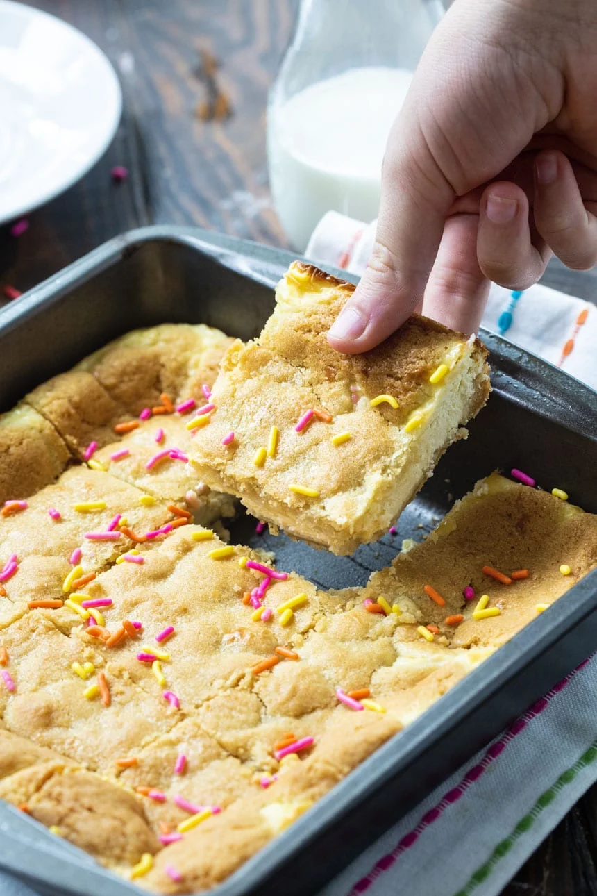 Cheesecake Bars made from Sugar Cookie dough in an 8-inch baking dish