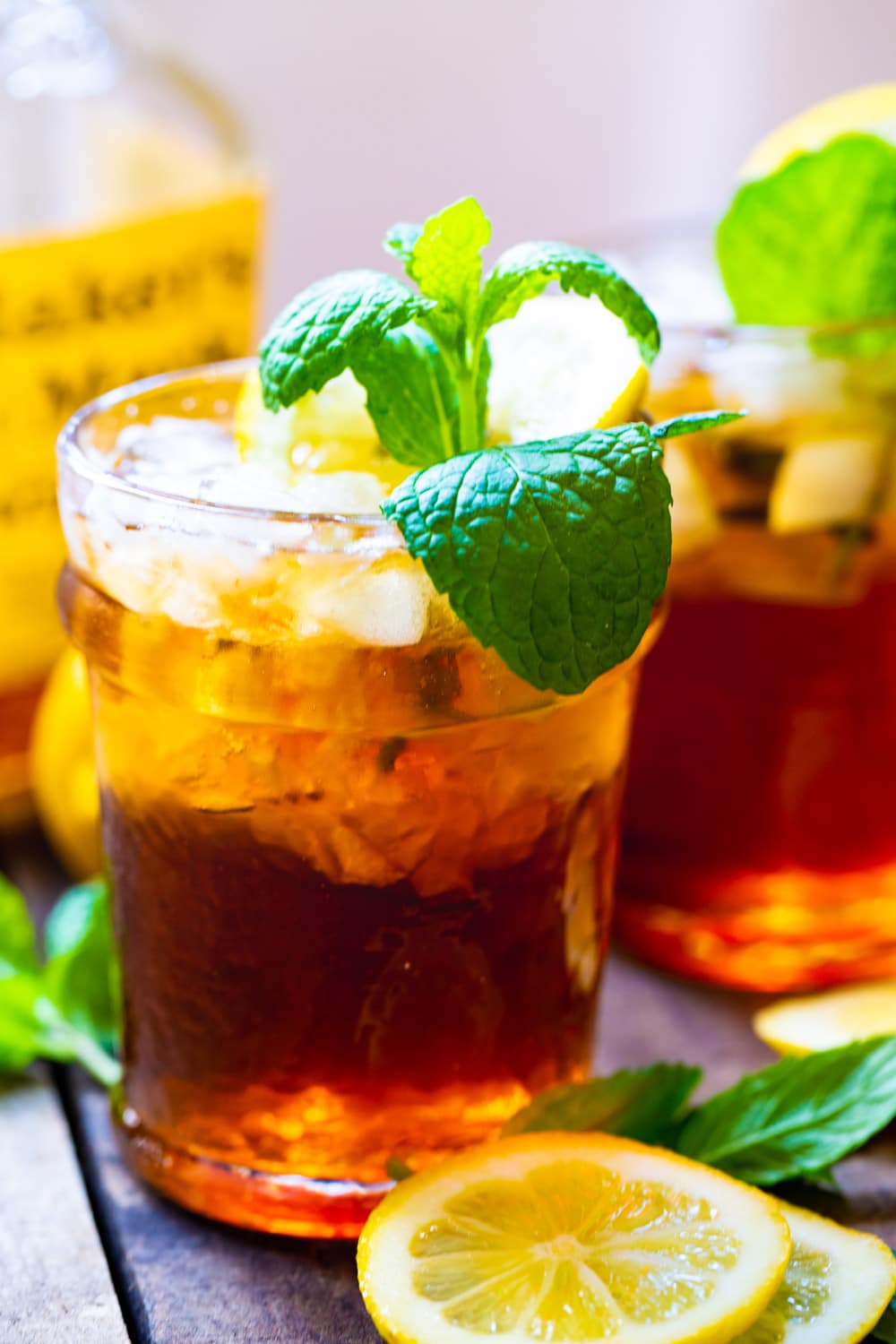 Sweet Tea Mint Juleps with bottle of bourbon.