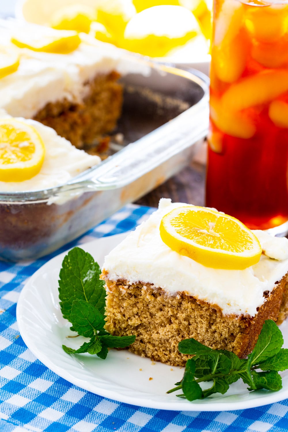 Slice of Sweet Tea and Lemonade Cake with glass of iced tea.