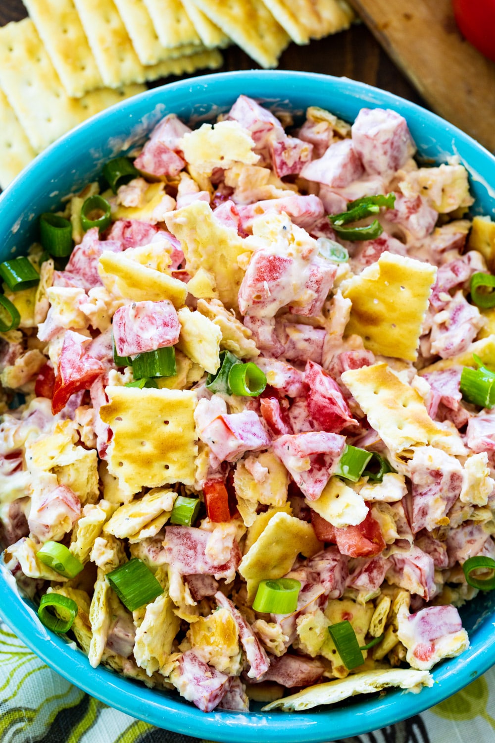 Overhead view of tomato salad with crackers.