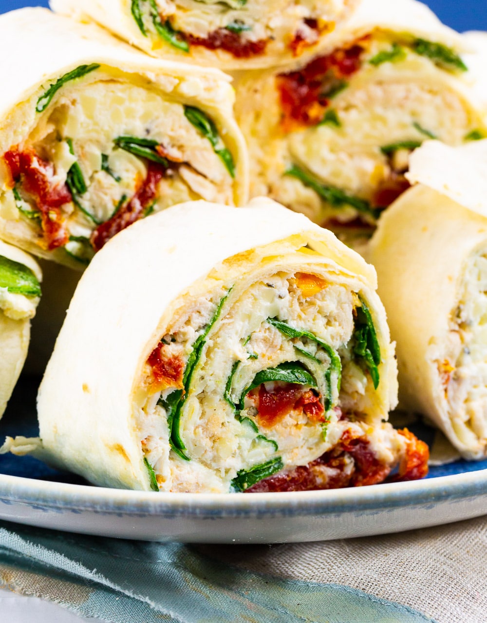 Close-up of a pinwheel filled with Tuscan chicken mixture.