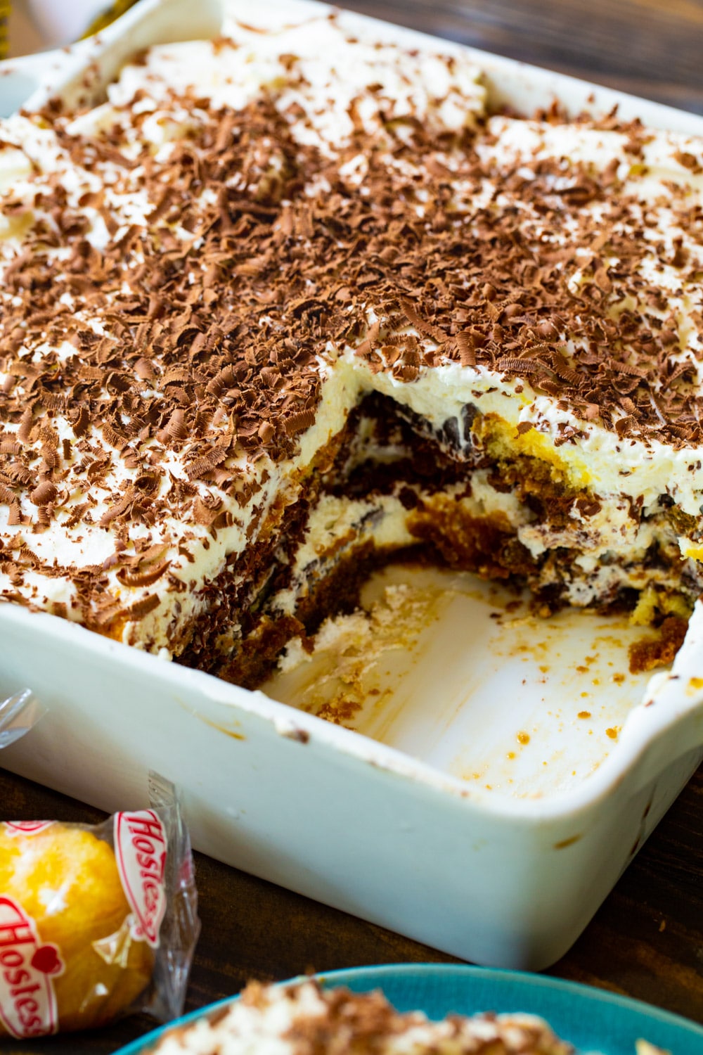 Tiramisu in serving dish with piece cut out.