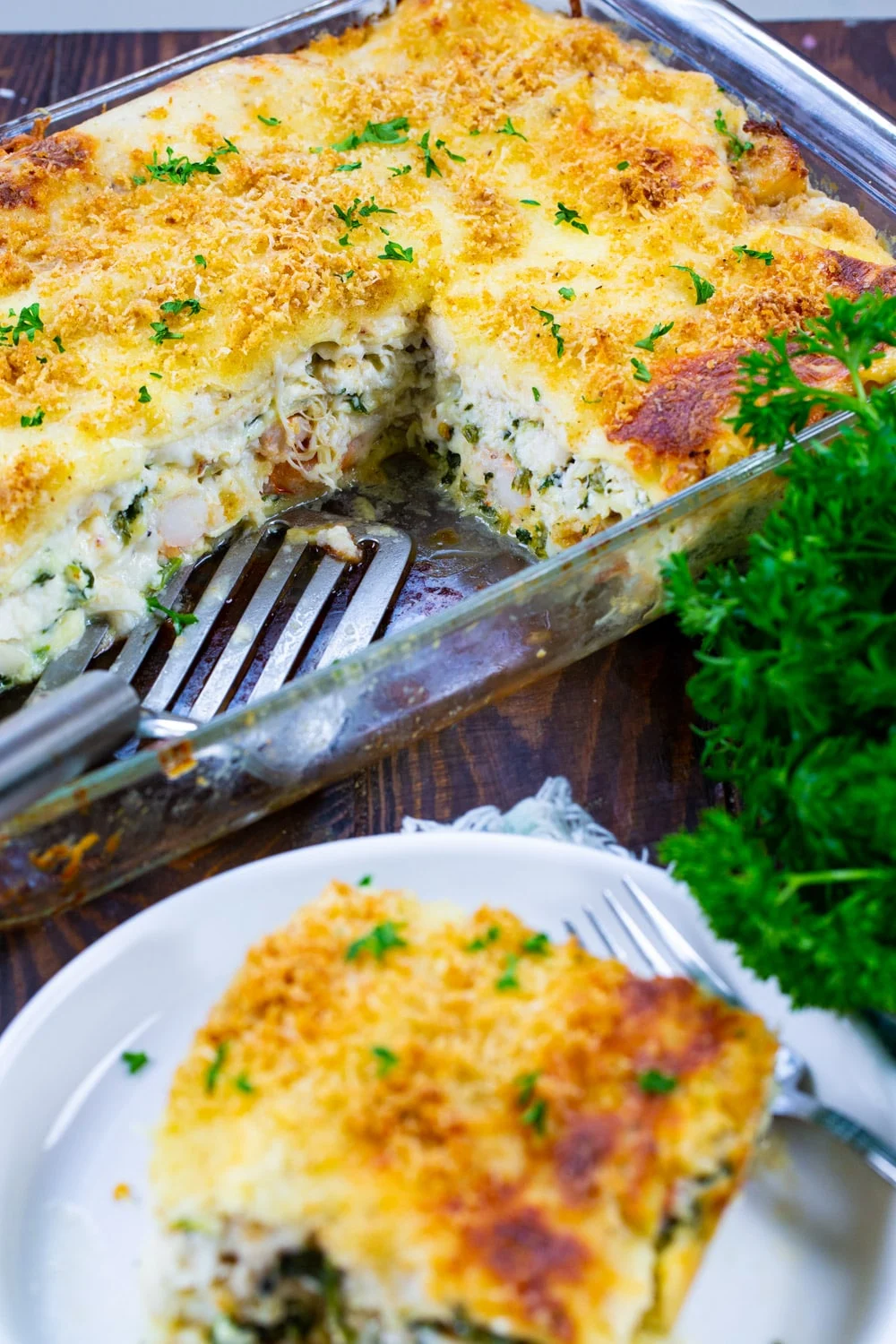 Seafood Lasagna in a baking pan with several pieces cut out.