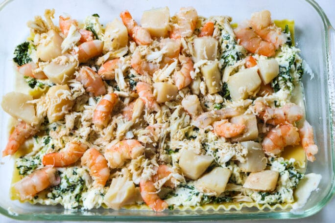Seafood mixture layered on top of ricotta.