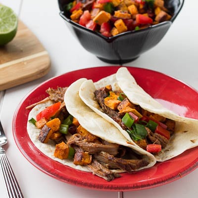 Chipotle Maple Beef Brisket Tacos on a red plate.