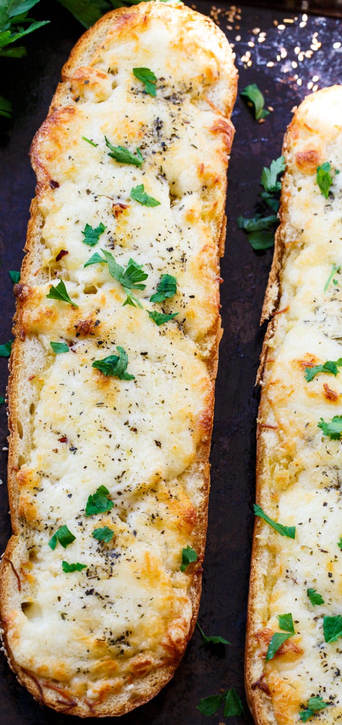 Cheesy Garlic Bread- lots of butter, mayo, garlic, and cheese make this bread insanely delicious!