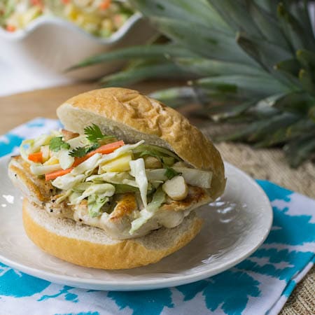 Chicken Sandwich with Pineapple Slaw on a white plate.