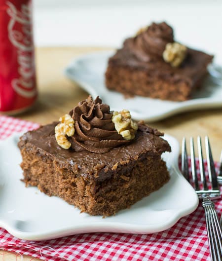 Coca Cola Cake on a small white plate with coke can in background.