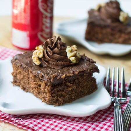 Coca Cola Cake on small plate with Coke can in background.
