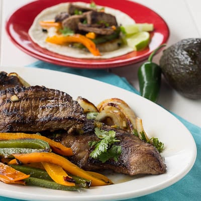 Grilled Skirt Steak Fajitas on a white serving platter.