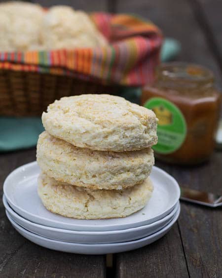 Three biscuits stacked on small white plates.