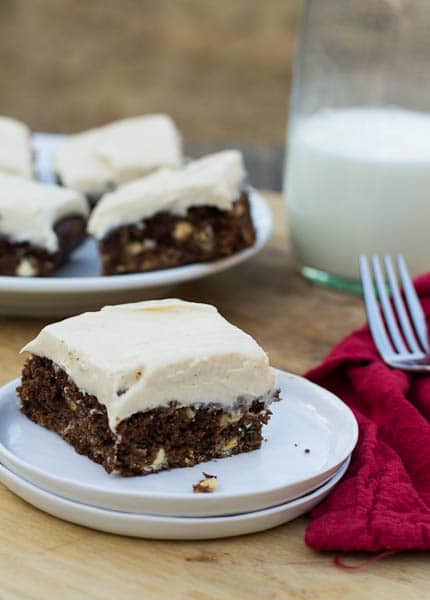 Gingerbread Brownie on a small white plate with more in background.