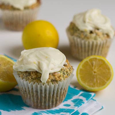 Lemon Poppy Seed Muffins surrounded by lemon halves.