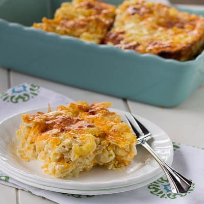 Slice of macaroni and cheese on a white plate.
