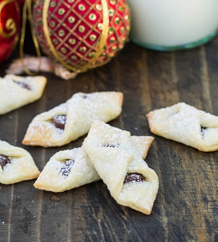 Bowtie Cookies with Nutella on a wooden board.