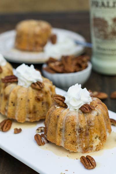 Mini Toffee Budt Cakes topped with whipped cream and pecans.