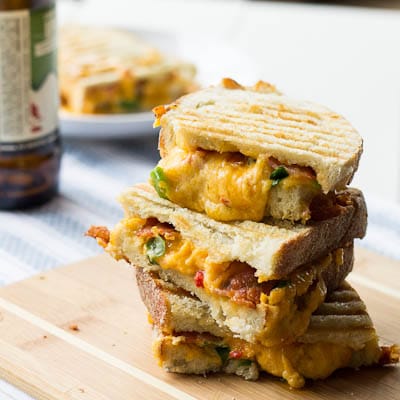 Cheese Panini Sandwich cut in half and stacked on a cutting board.