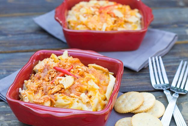 Mac and Pimiento Cheese in red baking dish with ritz crackers beside it.