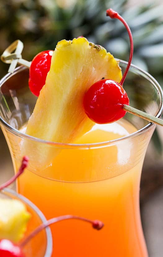 Pineapple Upside Down Cocktail in a hurricane glass.