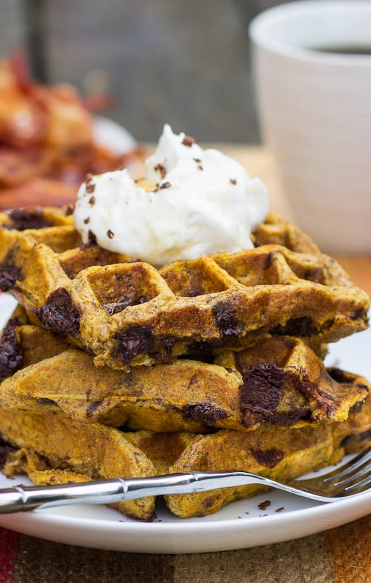 Close-up of Pumpkin-Chocolate Chip Waffles stacked on a plate.