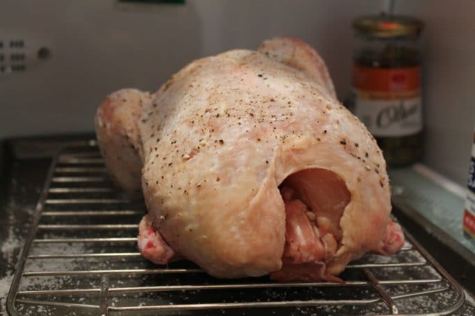 Uncooked chicken in refrigerator.