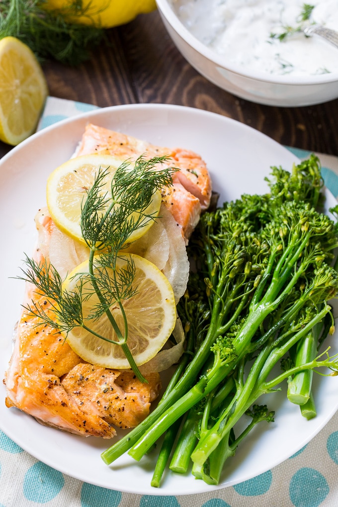 Salmon is baked in the oven with onion and lemon slices.