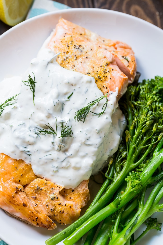 Salmon is baked in the oven and covered with a creamy dill sauce.