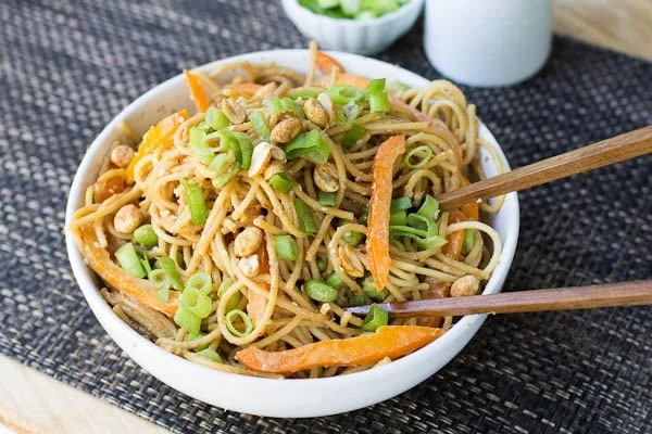White bowl full of peanut noodles.