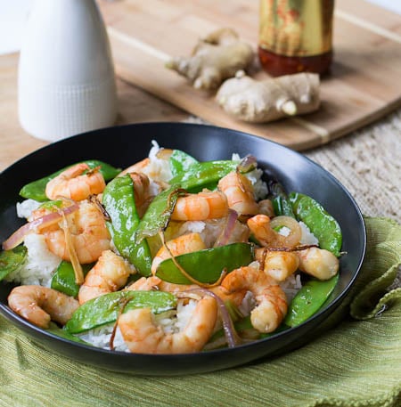 Gingered Stir Fry with Shrimp and Snow Peas in black bowl.