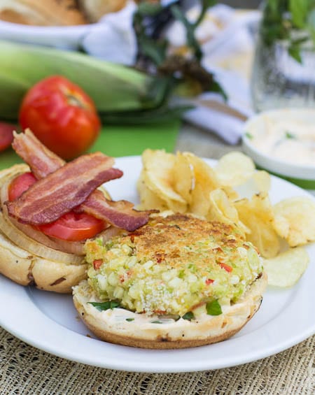 Succotash Burger on a plate with potato chips.