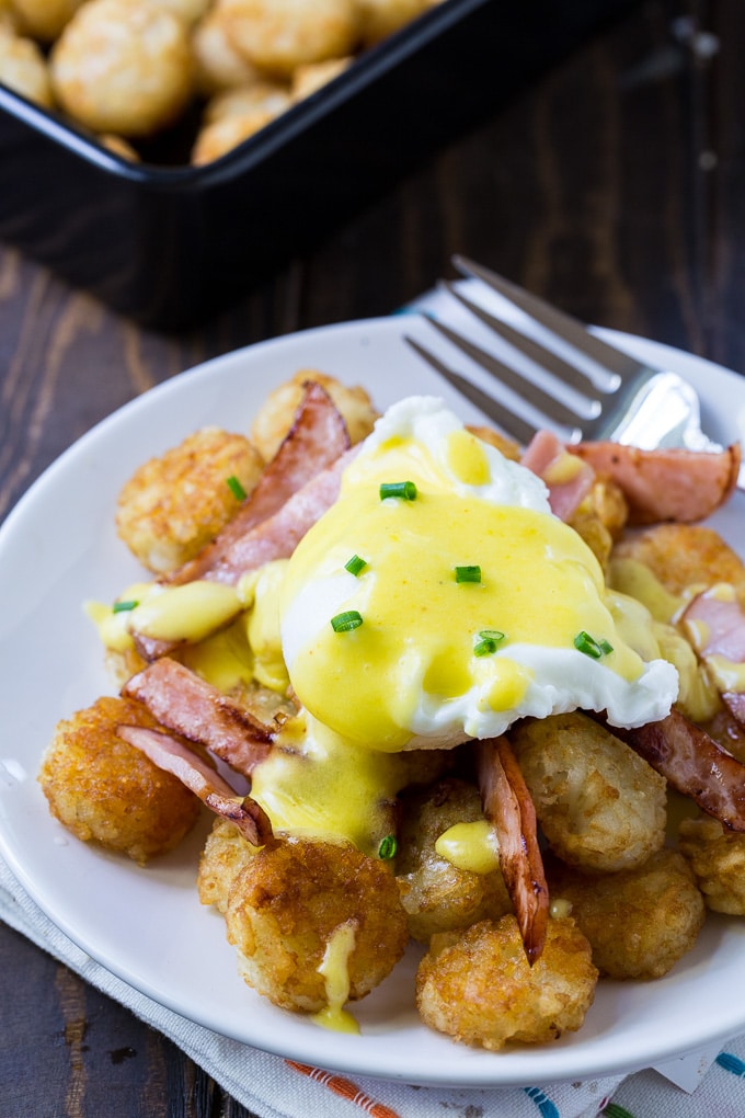Tater Tor Eggs Benedict on a crispy bed of tater tots with canadian bacon.