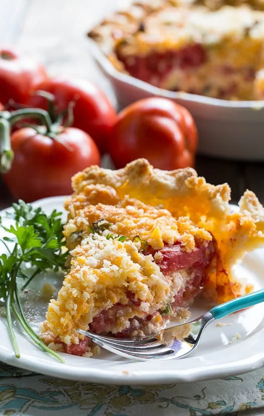 Savory Tomato Pie Recipe- a southern favorite. Juicy summer tomatoes mixed with mayonnaise and cheddar cheese. Serve warm.