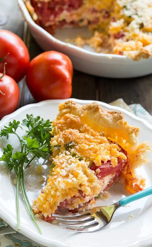 Savory Tomato Pie Recipe- a southern favorite. Juicy summer tomatoes mixed with mayonnaise and cheddar cheese. Serve warm.