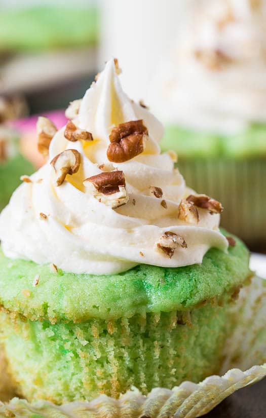 Watergate Cupcakes flavored with pistachio pudding and pineapple. Topped with marshmallow fluff frosting.